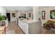 Modern kitchen island with white cabinets and quartz countertops at 12406 W Allegro Dr, Sun City West, AZ 85375