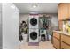 Laundry room with washer, dryer, and extra storage at 12406 W Allegro Dr, Sun City West, AZ 85375