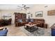 Spacious living room featuring a large leather sectional sofa and a wood coffee table at 12406 W Allegro Dr, Sun City West, AZ 85375