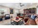 Cozy living room boasting a brown leather sectional, wooden coffee table, and a charming atmosphere at 12406 W Allegro Dr, Sun City West, AZ 85375