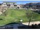 View of a well-maintained green common area in a residential community with mulit-story apartment buildings and reserved parking spaces at 1255 N Arizona Ave # 1297, Chandler, AZ 85225