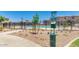 View of community pool, landscaping, and pet waste station, offering convenience for pet owners at 1255 N Arizona Ave # 1297, Chandler, AZ 85225