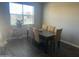 Cozy dining room featuring a wooden table with six chairs, window, and a plant stand at 1255 N Arizona Ave # 1297, Chandler, AZ 85225