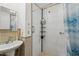 Clean bathroom with tiled shower, pedestal sink, and updated fixtures at 1521 W Garfield St, Phoenix, AZ 85007