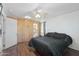 Bright bedroom with dark bedding and a ceiling fan at 1521 W Garfield St, Phoenix, AZ 85007