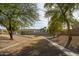 Landscaped backyard with mature trees and a pathway at 1523 E Constance Way, Phoenix, AZ 85042