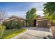 Tan two-story house with a three-car garage and lush landscaping at 1523 E Constance Way, Phoenix, AZ 85042