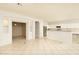 Open kitchen with island, white cabinets, and tile floor at 1523 E Constance Way, Phoenix, AZ 85042