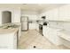 Kitchen boasts white cabinets, stainless steel appliances, and tile flooring at 1523 E Constance Way, Phoenix, AZ 85042