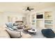 Living room with built-in shelving and a large TV at 1523 E Constance Way, Phoenix, AZ 85042