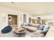 Living room with beige sectional sofa and wooden coffee table at 1523 E Constance Way, Phoenix, AZ 85042