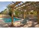 Peaceful pergola-covered patio overlooking the pool at 1523 E Constance Way, Phoenix, AZ 85042