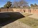 Landscaped backyard with gravel, grass, and various yard ornaments at 1534 E Alba Dr, Casa Grande, AZ 85122