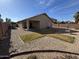 Backyard with gravel, grass, and a covered patio at 1534 E Alba Dr, Casa Grande, AZ 85122