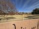 View of a grassy common area beyond a block wall at 1534 E Alba Dr, Casa Grande, AZ 85122