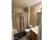 Bathroom with floral shower curtain, toilet, and vanity at 1534 E Alba Dr, Casa Grande, AZ 85122