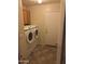 Laundry room with washer, dryer, cabinets, and access door at 1534 E Alba Dr, Casa Grande, AZ 85122