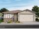 One-story home with two-car garage, stone accents, and landscaping at 15989 W Cottontail Ln, Surprise, AZ 85387