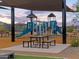 Modern playground with shade structures and picnic tables at 15989 W Cottontail Ln, Surprise, AZ 85387