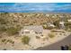 Aerial view of house with desert landscaping, driveway, and three-car garage at 16548 E Emerald Dr, Fountain Hills, AZ 85268