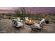 Evening view of backyard patio with fire pit and seating area at 16548 E Emerald Dr, Fountain Hills, AZ 85268