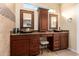 Double vanity bathroom with granite countertops and large mirrors at 16548 E Emerald Dr, Fountain Hills, AZ 85268