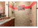 Bathroom with copper sink, red tile accents and a walk-in shower at 16548 E Emerald Dr, Fountain Hills, AZ 85268