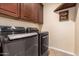 Laundry room with LG washer and dryer, and wooden cabinets at 16548 E Emerald Dr, Fountain Hills, AZ 85268