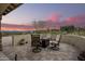 Relaxing patio with fire pit and seating area, enjoying sunset views at 16548 E Emerald Dr, Fountain Hills, AZ 85268