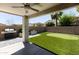 Covered patio with built-in grill and putting green at 18147 W Lundberg St, Surprise, AZ 85388