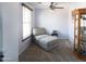 Bright bedroom with chaise lounge and built-in shelving at 18147 W Lundberg St, Surprise, AZ 85388