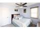 Guest bedroom with full-size bed and ceiling fan at 18147 W Lundberg St, Surprise, AZ 85388