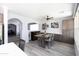 Bright dining area with a wooden table and chairs, adjacent to kitchen at 18147 W Lundberg St, Surprise, AZ 85388