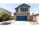 Two-story house with stone accents and a two-car garage at 18147 W Lundberg St, Surprise, AZ 85388