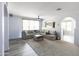 Bright living room with L-shaped sectional sofa and neutral decor at 18147 W Lundberg St, Surprise, AZ 85388