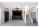 Living room with built-in entertainment center and stairs at 18147 W Lundberg St, Surprise, AZ 85388