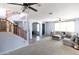 Open living room with staircase and neutral color scheme at 18147 W Lundberg St, Surprise, AZ 85388