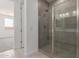 This luxurious bathroom features a tiled shower with glass door and neutral tile floors at 18225 W Hess St, Goodyear, AZ 85338