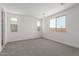 Neutral bedroom featuring carpet and large windows for plenty of natural light at 18225 W Hess St, Goodyear, AZ 85338