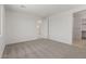 A carpeted bedroom features neutral walls, and views of an adjoining room at 18225 W Hess St, Goodyear, AZ 85338