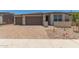 Charming single-story home with a three-car garage and brick paved driveway at 18225 W Hess St, Goodyear, AZ 85338