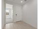 Bright foyer with neutral tile flooring and a view into a bedroom at 18225 W Hess St, Goodyear, AZ 85338