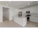 Modern kitchen with white cabinets, stainless steel appliances, and a central island at 18225 W Hess St, Goodyear, AZ 85338