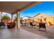 Spacious backyard patio with seating area and partial view of the backyard at 18258 W Spencer Dr, Surprise, AZ 85374