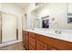 Main bathroom with double vanity, shower, and ample storage at 18258 W Spencer Dr, Surprise, AZ 85374