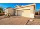 View of the home's front and garage, with a brick driveway at 18258 W Spencer Dr, Surprise, AZ 85374