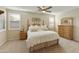 Spacious bedroom with wood furniture and a ceiling fan at 1893 E San Carlos Pl, Chandler, AZ 85249