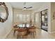 Elegant dining room with glass-top table, leather chairs, and plantation shutters at 1893 E San Carlos Pl, Chandler, AZ 85249