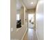 Hallway with wood-look floors and a view into a bedroom at 1893 E San Carlos Pl, Chandler, AZ 85249