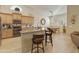 Granite kitchen island, stainless steel appliances, and light wood cabinets at 1893 E San Carlos Pl, Chandler, AZ 85249